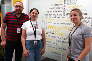 Three staff members from Spectrum's Migration Liaison team